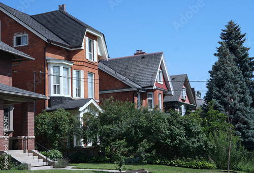 Street of modest middle class homes with front yards © Spiroview Inc.