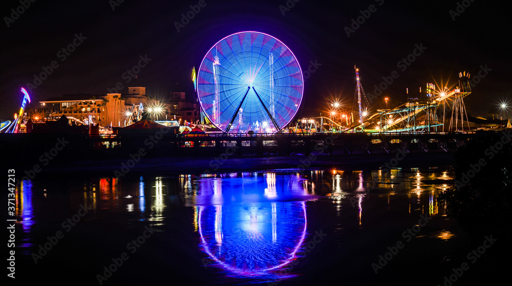 Ferris wheel spinning at the fair at night