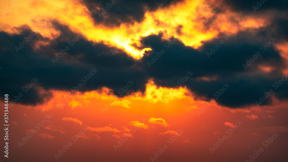 Sun in the clouds, dramatic sunset