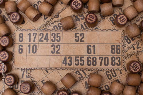 Old Wooden Lotto barrels with playing cards. Table Game Bingo