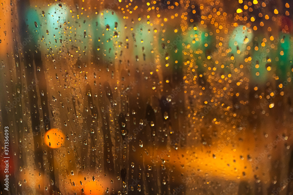 The view from the plane window of the night airport during heavy rain. Selective focus. Blurred image