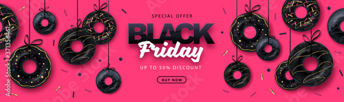 Black friday big sale poster with black sweet donuts on pink background