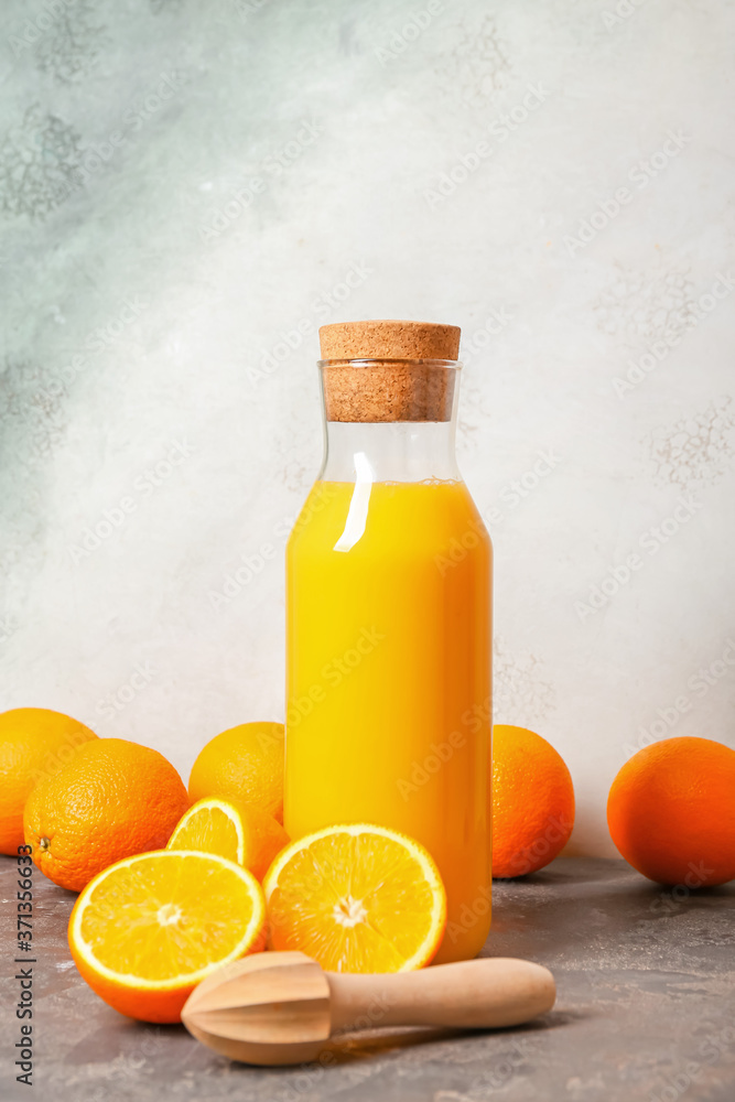 Bottle of fresh orange juice on table Bottle of fresh orange juice on table