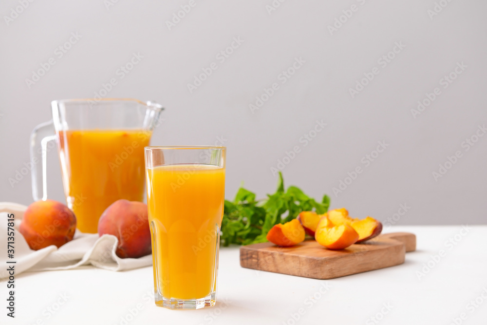 Glass of tasty peach juice on table Glass of tasty peach juice on table