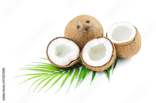 Coconut with coconut palm leaves isolated on white background. Fresh raw organic half coconut. Healthy food, skin care concept. Vegan food