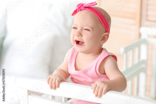 Cute little baby in bed at home