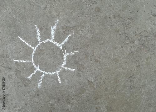 the sun is drawn with chalk on the asphalt. summer. banner place for text, children creativity