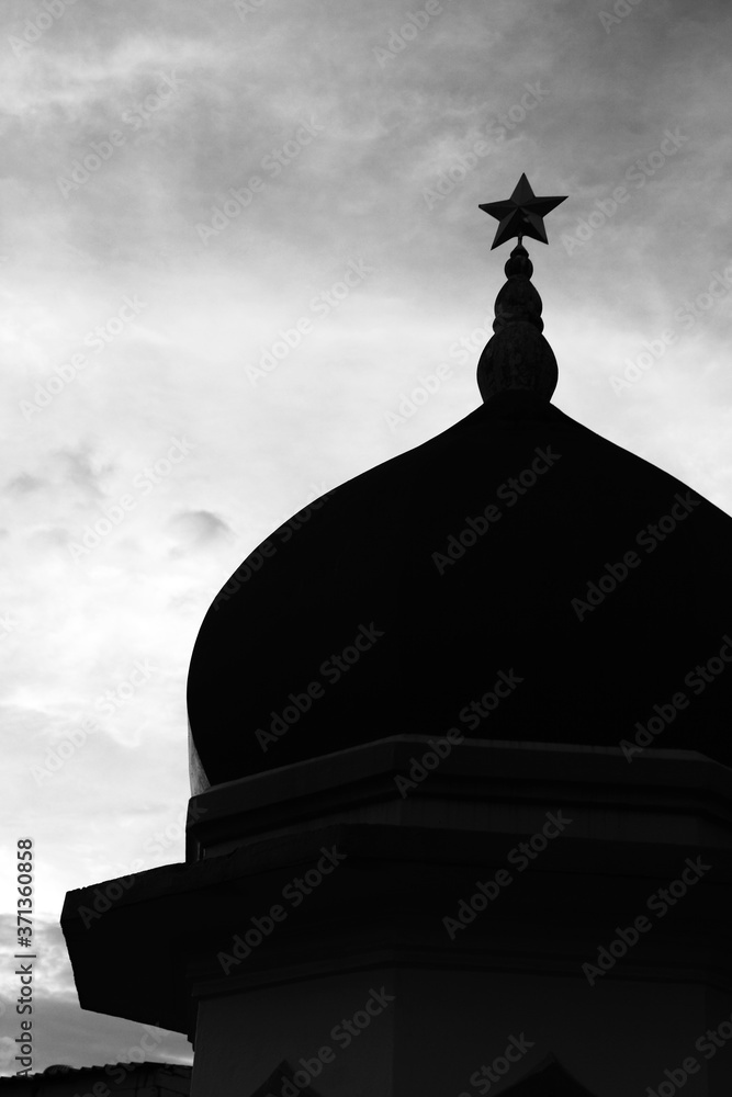 Silhouette of mosque at sunset