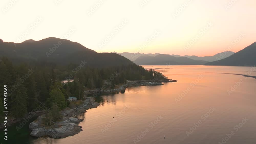 Aerial View of Mermaid Cove during a colorful summer sunrise. Taken in Saltery Bay, Sunshine Coast, British Columbia, Canada. Aerial View of Mermaid Cove during a colorful summer sunrise. Taken in Saltery Bay, Sunshine Coast, British Columbia, Canada.