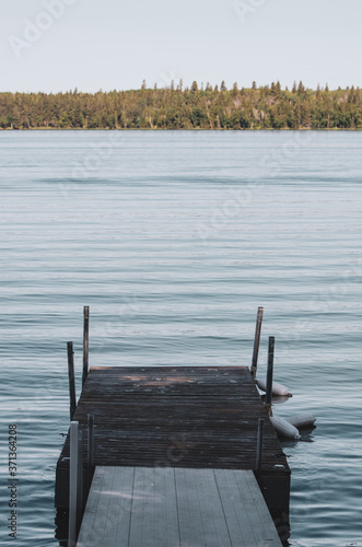 Calm morning on a dock on Child's Lake in Duck Mountain Provincial Park, Manitoba, Canada photo