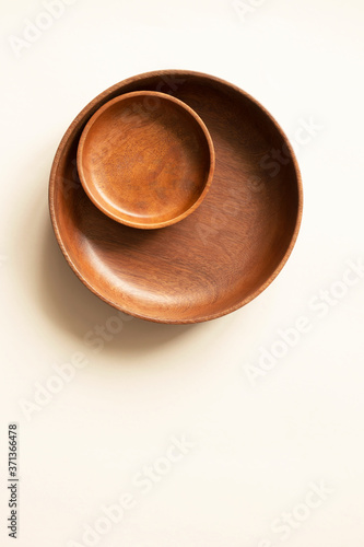 Empty two wooden plates, above. Round dishes on light beige background with copy space. Mockup for menu or recipe, vertical