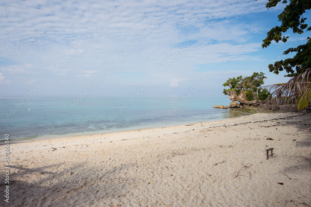 beautiful white sand beach and turquoise water with some trees