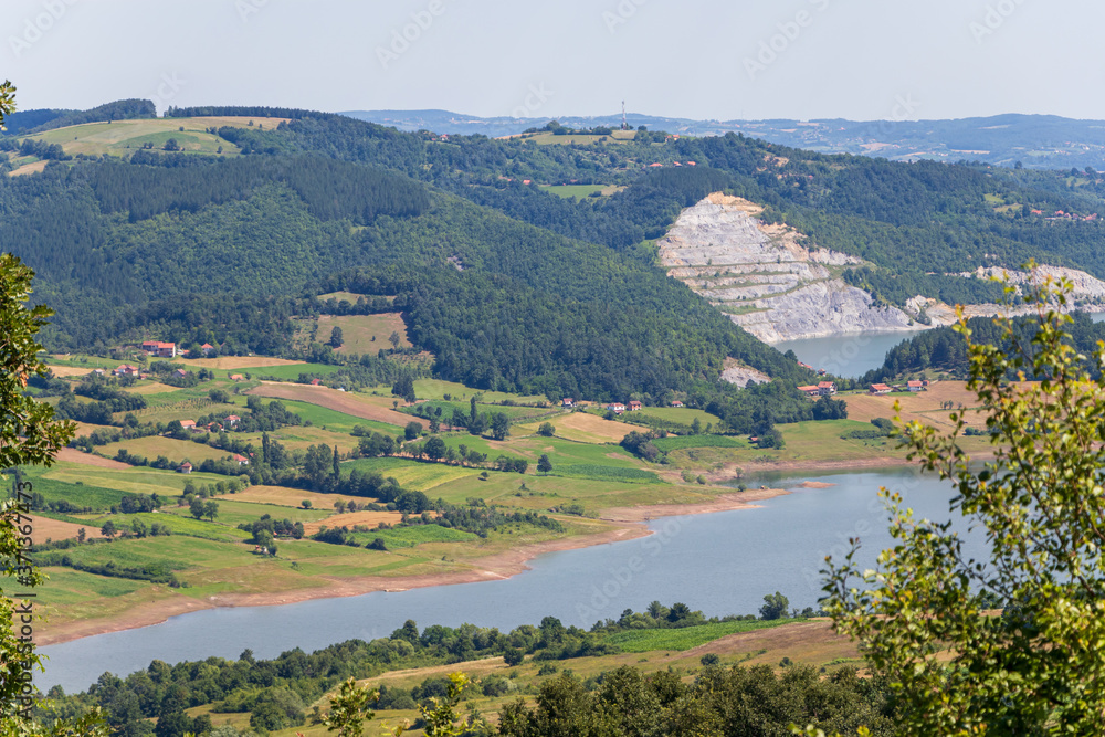 Green rolling fields and forest with mountains and river in Tara national park in Serbia