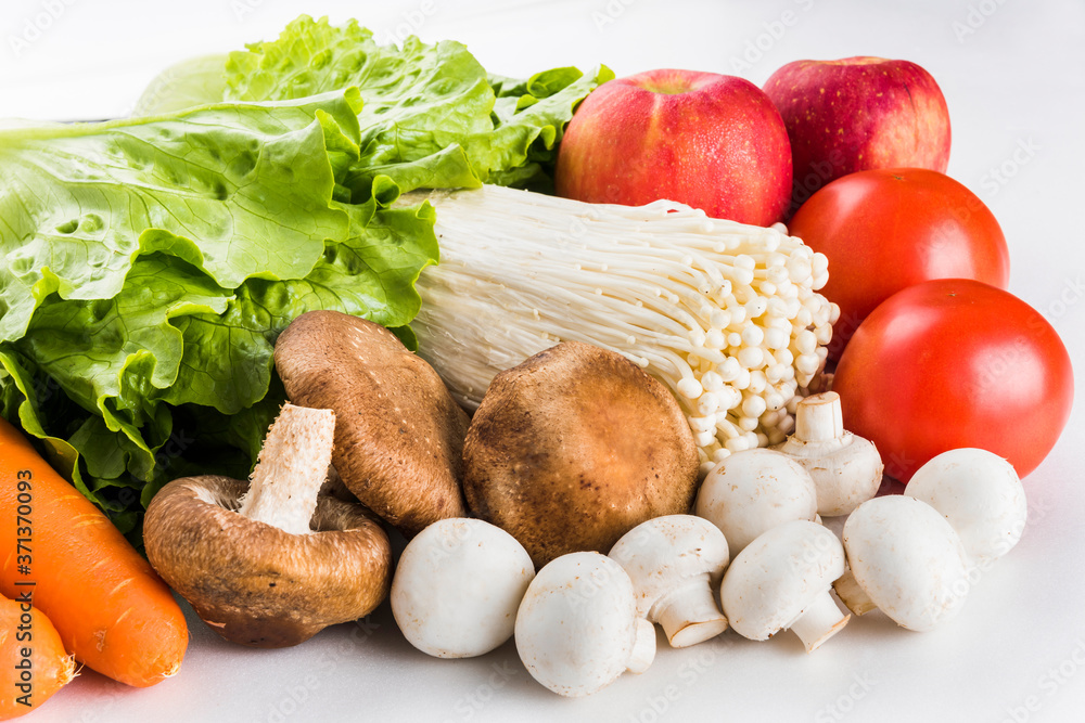 Close-up fresh green lettuce and vegetables on white background Close-up fresh green lettuce and vegetables on white background