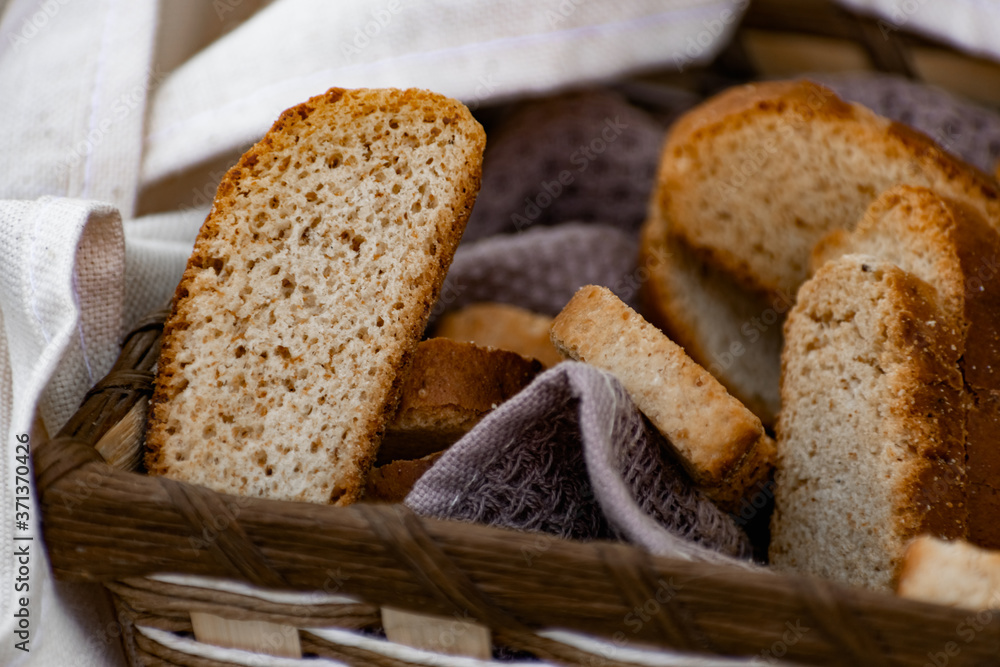 Vanilla crackers for tea, simple sweet crunchy snack in a wicker basket on natural fabric, picnic in nature
