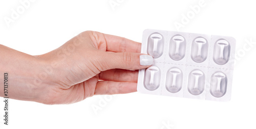 Hand with medical pills in blister, isolated on white background.