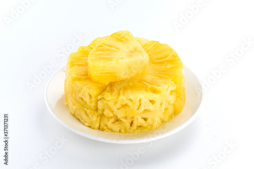 Sliced pineapple on a white background, it is a sweet and juicy fruit.