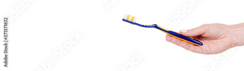 Hand with blue and yellow plastic toothbrush, dental care. Isolated on white background, copy space template, banner.