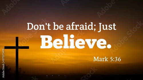 Valokuva bible verse about dont be afraid just believe with jesus cross symbol  on dark e