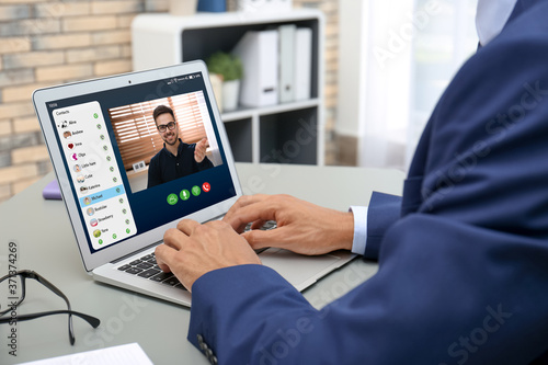 Man having online meeting with his colleague via laptop  closeup