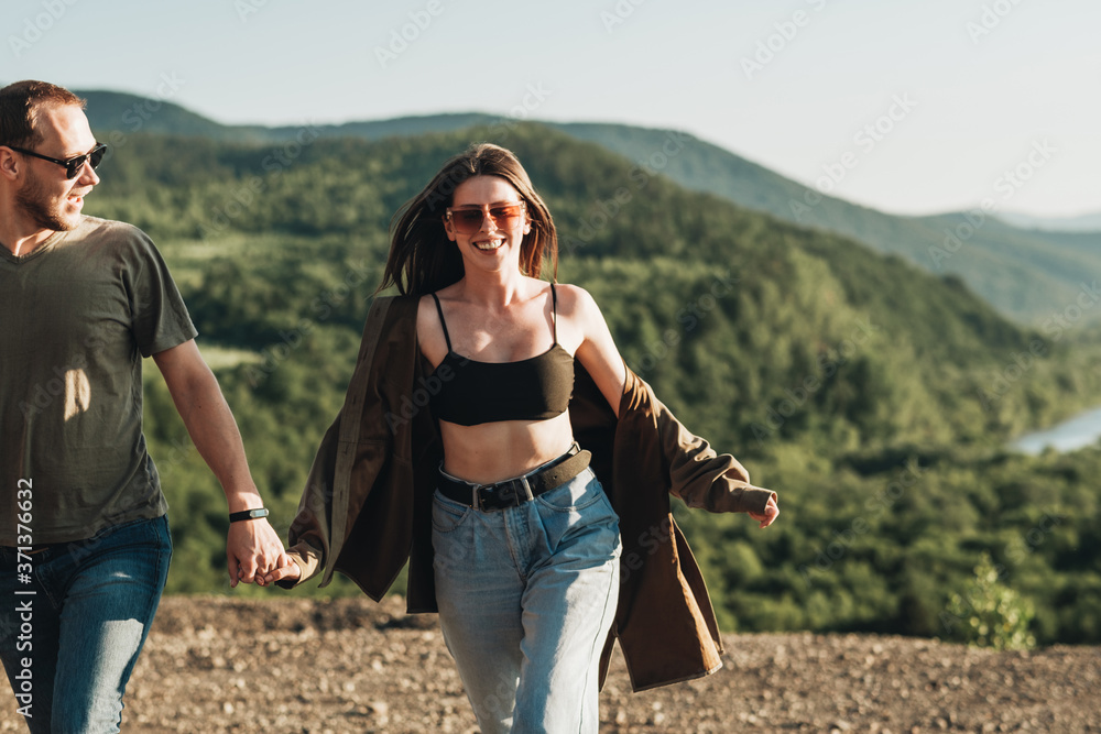 Young Traveler Couple on a Trip, Man and Woman Enjoying Journey Over Beautiful Landscape