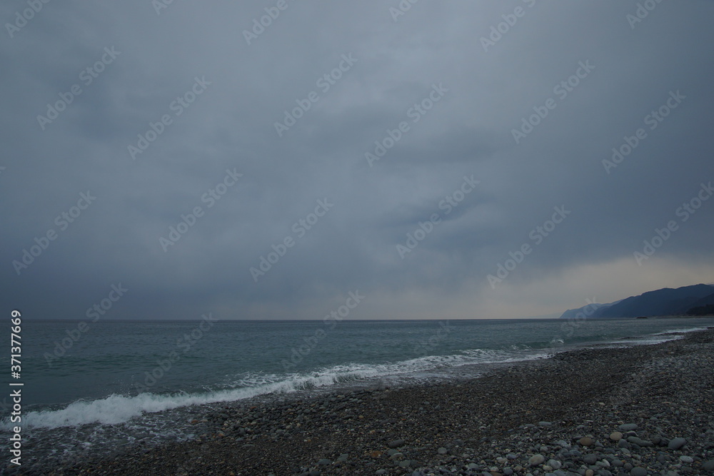 Overcast sky with dark cloud and sea in windy day.