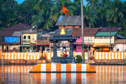 27.12.2019 Gokarna, Karnataka, Colorful indian Koteshwar temple bright orange-striped on the bank of sacred lake Koti Teertha. The city is a holy pilgrimage site for Hinduists photo