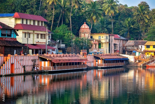 27.12.2019 Gokarna, Karnataka, Colorful indian houses, bright orange-striped temple tank on the bank of sacred lake Koti Teertha. The city is a holy pilgrimage site for Hinduists photo