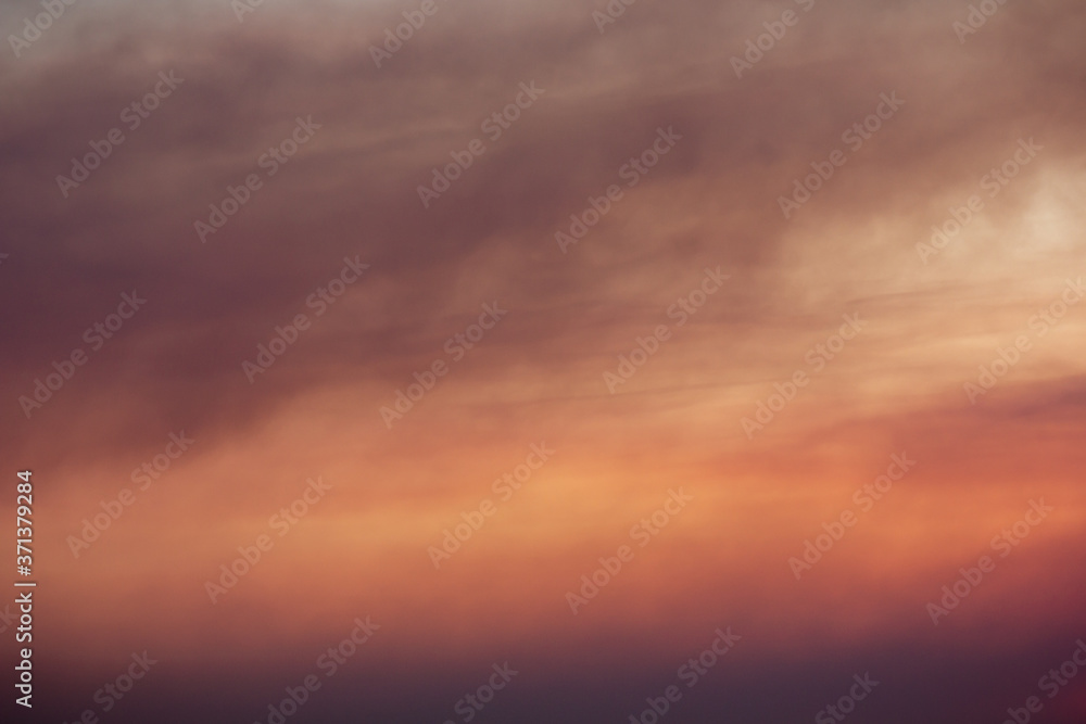 Colorful and beautiful view on dramatic cloudscape in the sunset. Dark cloudy overcast background.