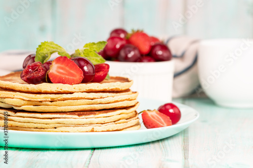 Pancake breakfast. Homemade pancakes with fresh berry and honey  light background