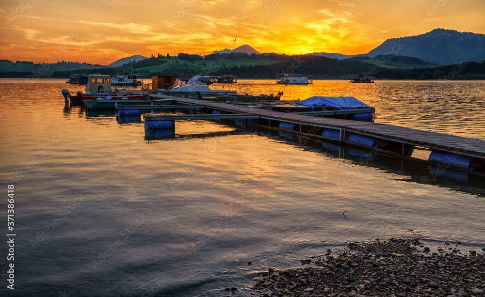 Colorful sunset on lake Liptovska Mara, Slovakia. Boats in port