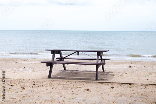 Empty wooden table by the sea