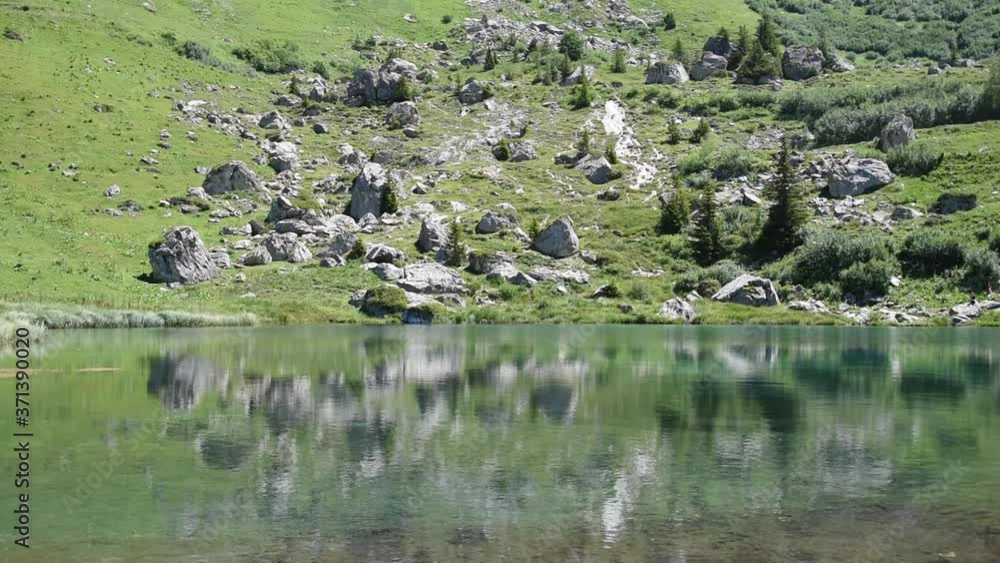 Beautiful high mountain lake in French Alps and reflexions