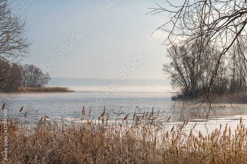 First snow and morning frosts with fog on the USA river