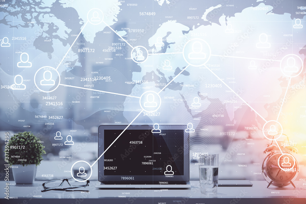 Computer on desktop with social network hologram. Double exposure. Concept of international people connections. Computer on desktop with social network hologram. Double exposure. Concept of international people connections.