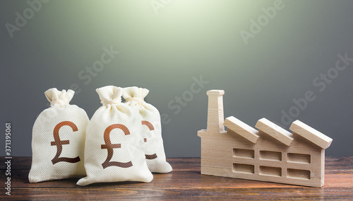 Obraz na plátně British pound sterling money bags and industrial factory plant