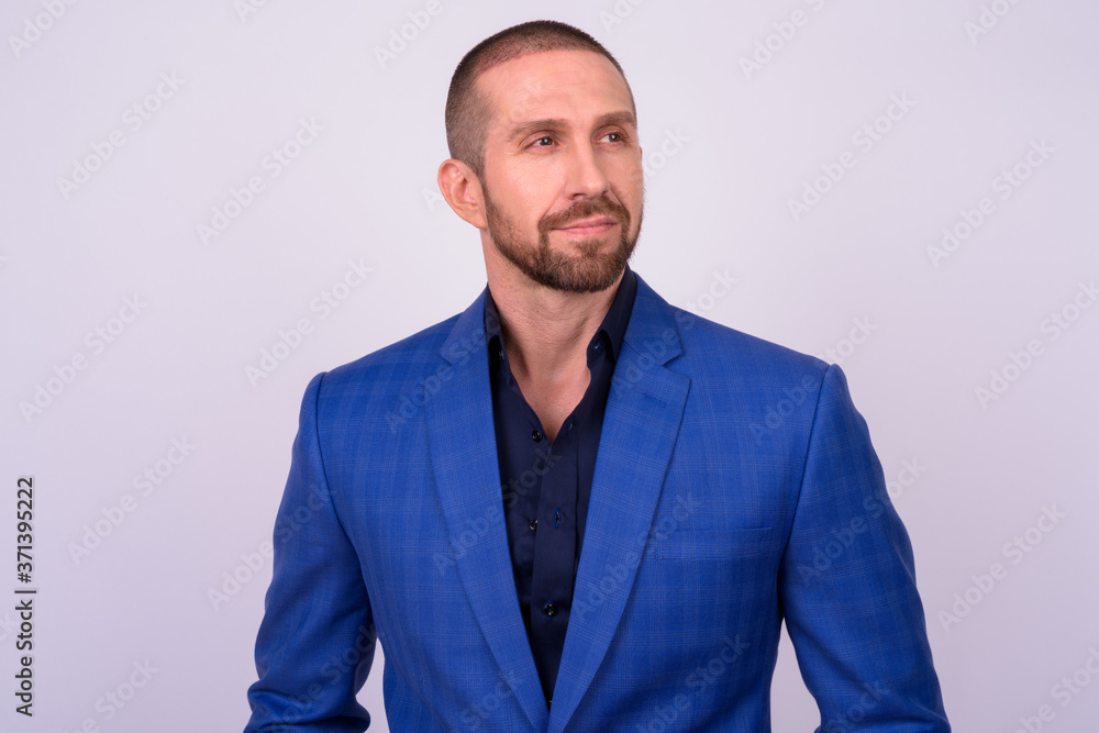 Portrait of handsome bald bearded businessman in suit Portrait of handsome bald bearded businessman in suit