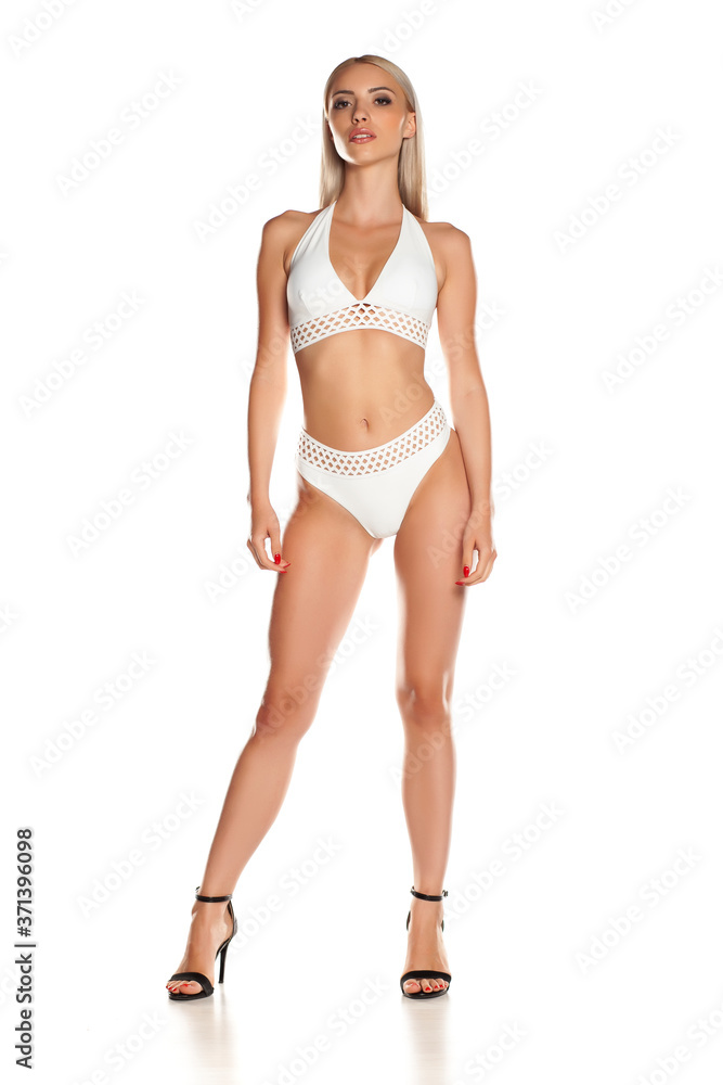Woman in white bikini, isolated on white background.