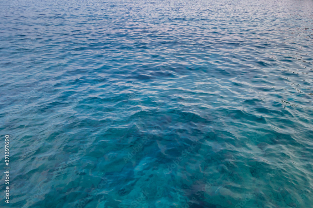 View onto surface of sea near shoreline. Some underwater stones seen through depth of water View onto surface of sea near shoreline. Some underwater stones seen through depth of water