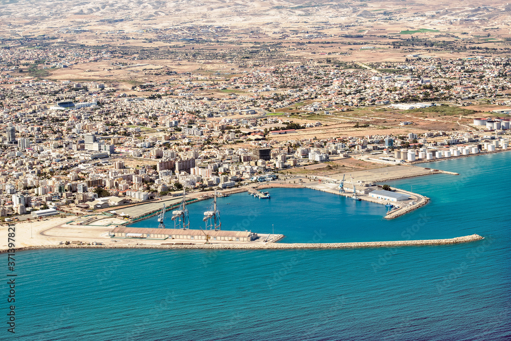 Fragment of the seaport of Larnaca, Cyprus. View from the aircraft to the coastline, beaches, seaport and the architecture of the city of Larnaca.