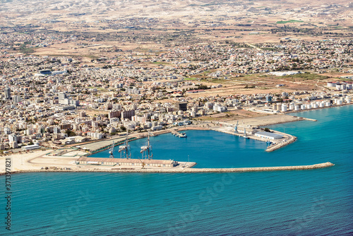 Fragment of the seaport of Larnaca, Cyprus. View from the aircraft to the coastline, beaches, seaport and the architecture of the city of Larnaca.