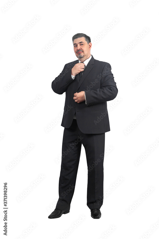 Male businessman in a suit straightens his tie and smiles Male businessman in a suit straightens his tie and smiles