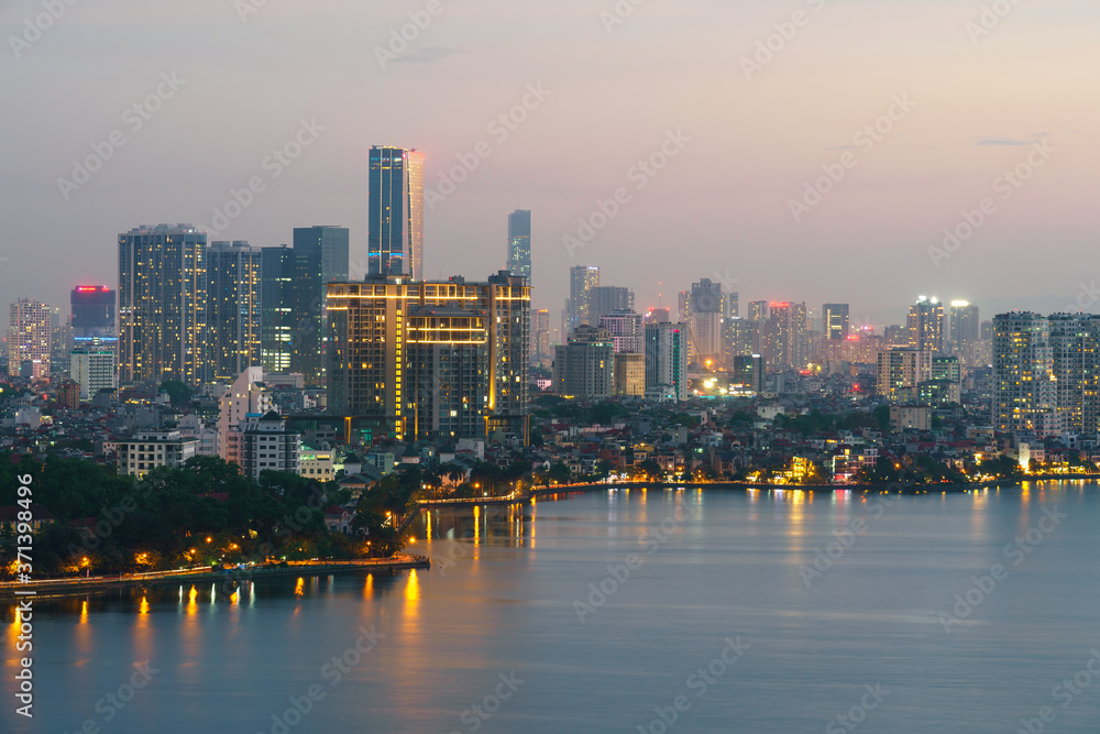 Obraz premium Hanoi cityscape with skyline view during sunset period at West Lake ( Ho Tay ) in 2020