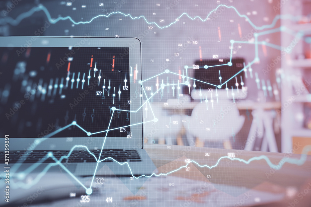 Stock market chart hologram drawn on personal computer background. Multi exposure. Concept of investment. Stock market chart hologram drawn on personal computer background. Multi exposure. Concept of investment.