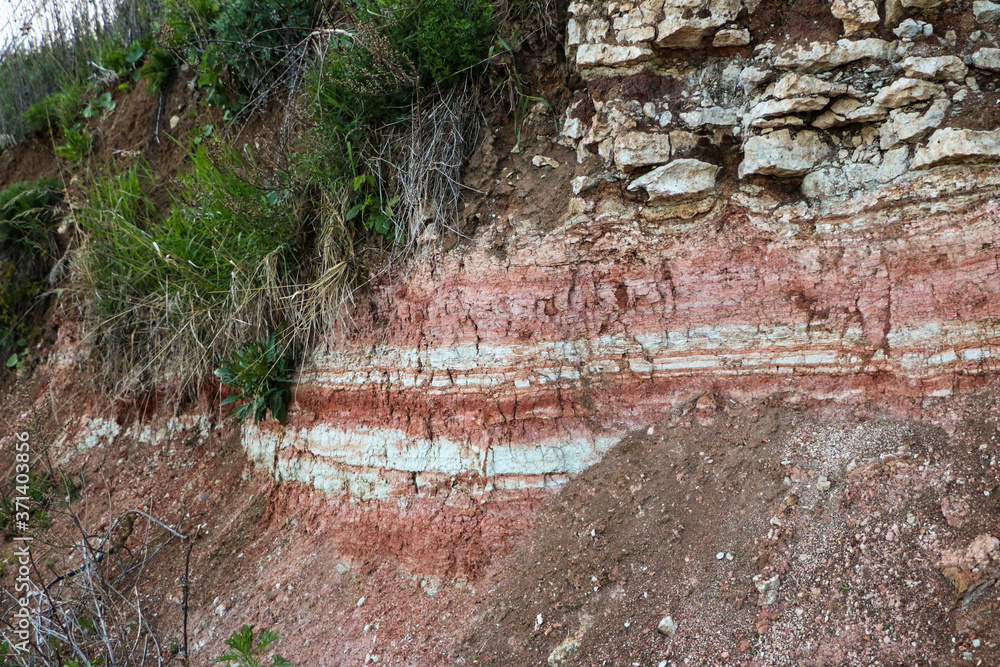 textures of various clay layers underground in clay quarry after geological study of soil. colored layers of clay and stone in section of earth, different rock formations and soil layers. textures of various clay layers underground in clay quarry after geological study of soil. colored layers of clay and stone in section of earth, different rock formations and soil layers.