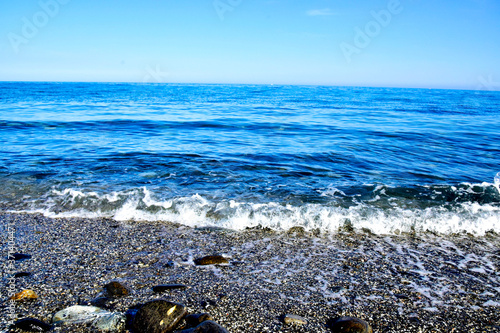 waves and surf on the amen seashore in sunny day