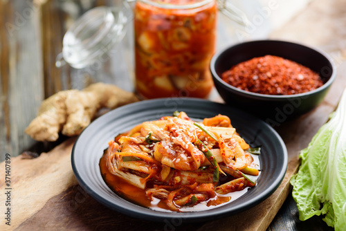 Kimchi cabbage with ingredients on wooden table, Korean food