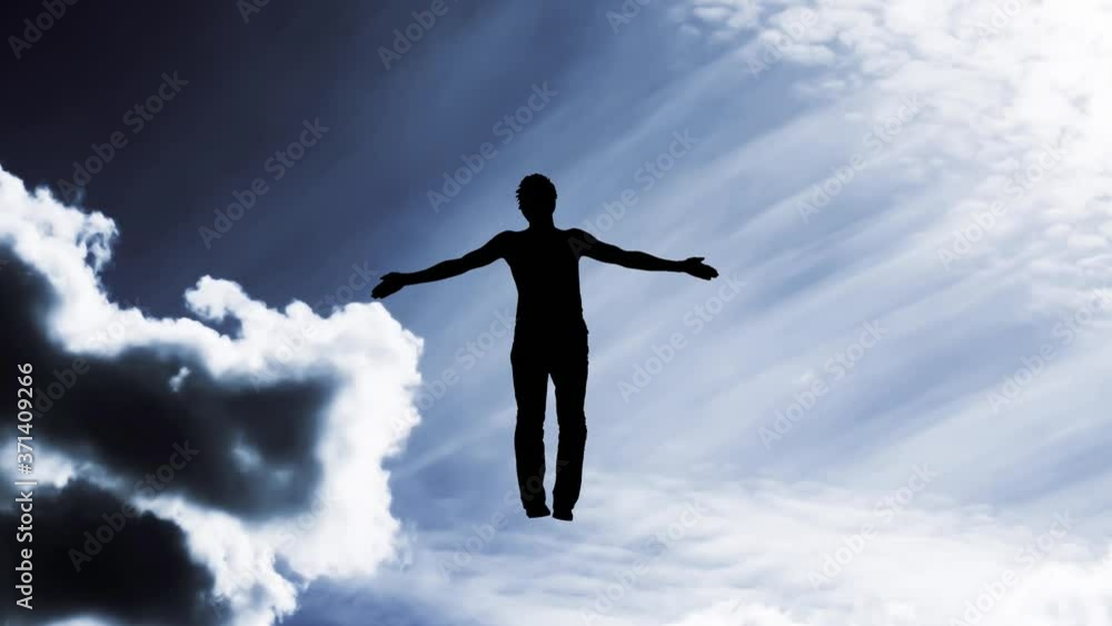 Creative 4K parallax video of the sky, moving clouds and sunlight, a silhouette of a man with arms spread apart, flying in a light and dissolving into it against the background of the Yin-Yang symbol. Creative 4K parallax video of the sky, moving clouds and sunlight, a silhouette of a man with arms spread apart, flying in a light and dissolving into it against the background of the Yin-Yang symbol.