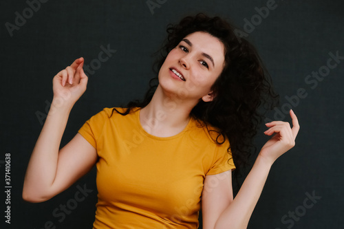 Portrait of young cute emotional caucasian female on grey background.