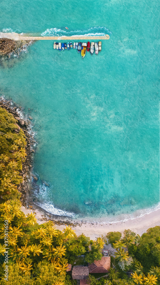 View from the drone on the azure sea with a natural shoreline.
